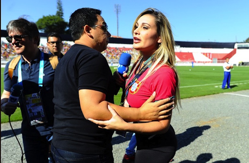 Andressa Urach (centre), a former contestant in Brazil's Miss BumBum pageant, is escorted out of the Portugal team training ground in Campinas, Sao Paulo, on June 19, 2014, during the 2014 FIFA World Cup. u00e2u20acu201d AFP pic