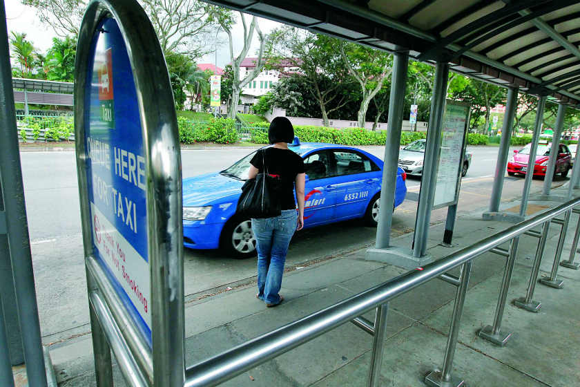 A passenger hails a cab in Singapore.  u00e2u20acu2022 Today pic