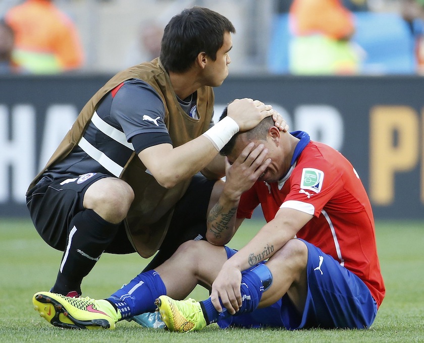 Chile's Gary Medel is comforted by goalkeeper Johnny Herrera after losing their 2014 World Cup round of 16 game against Brazil at the Mineirao stadium in Belo Horizonte June 29, 2014.u00c2u00a0u00e2u20acu201du00c2u00a0Reuters pic