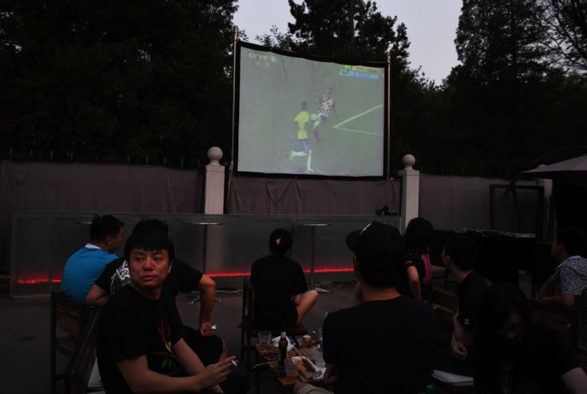 Chinese football fans watch the opening match of the World Cup 2014 projected live in a Beijing park. A few Chinese companies have adjusted their working hours during the World Cup, winning plaudits for understanding viewers' desires. u00e2u20acu201d AFP pic