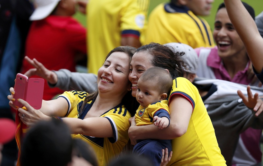 Soccer fans take a photograph during Colombia's national team training session in Cotia, June 9, 2014. u00e2u20acu201d Reuters pic