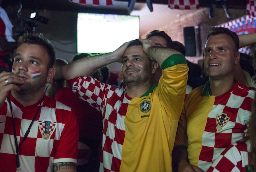Croatian fans Mario Pincic (centre) and Gordan Maricevic (right) react during the opening  match of the 2014 World Cup wearing composite Croatian/Brazilian jerseys in the Astoria neighborhood of Queens, New York June 12, 2014.u00c2u00a0u00e2u20acu201d Reuters pic