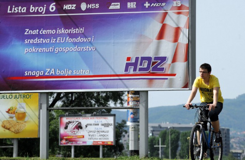 A man cycles past a billboard for the Croatian Democratic Union (HDZ) and coalition partners in Zagreb, Croatia, on May 23, 2014 before Croatians vote to choose its 11 representatives to the European Parliament. u00e2u20acu201d AFP pic