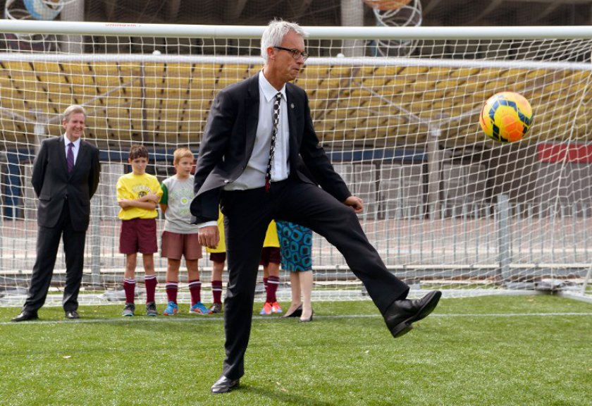 Football Federation Australia (FFA) chief executive David Gallop (C) kicks a ball after an announcement in Sydney on March 3, 2014, that the Socceroos will meet South Africau00e2u20acu2122s national team in a World Cup farewell match in Sydney on 26 May before depart