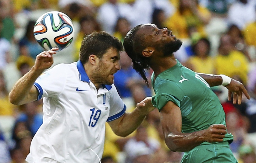 Greeceu00e2u20acu2122s Sokratis Papastathopoulos (left) fights for the ball with Ivory Coast's Didier Drogba during their 2014 World Cup Group C match at the Castelao arena in Fortaleza June 24, 2014. u00e2u20acu201d Reuters pic