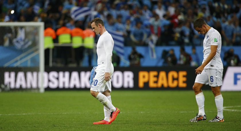 England's Wayne Rooney (left) and his teammate Phil Jagielka walk off the pitch at the end of their 2014 World Cup Group D football match against Uruguay at the Corinthians arena in Sao Paulo June 20, 2014. u00e2u20acu201d Reuters pic