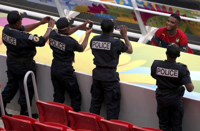 Cameroon's Samuel Eto'o poses for policemen to take his photograph during a team training session at the national stadium in Brasilia ahead of their 2014 World Cup Group A match against Brazil June 23, 2014.u00c2u00a0u00e2u20acu201d Reuters pic