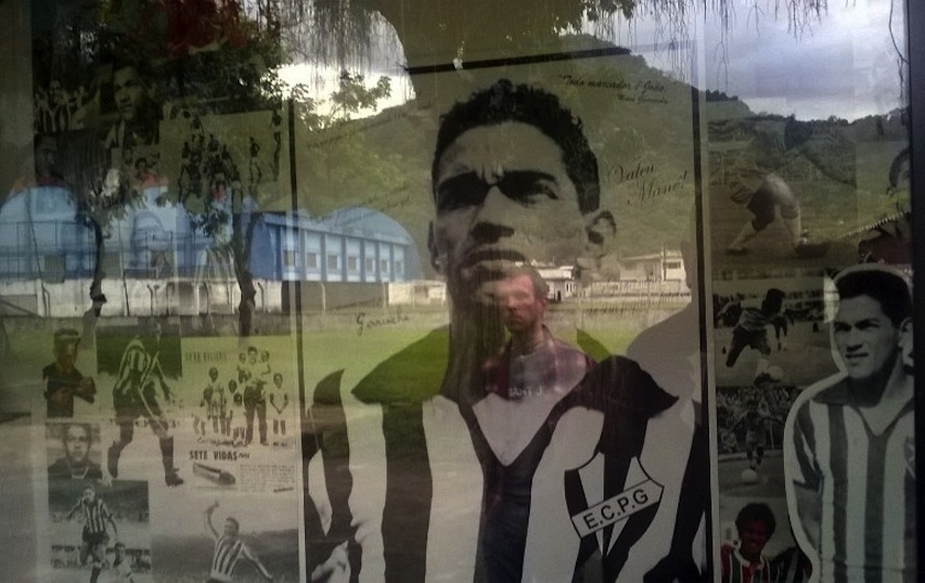 Pictures of legendary Brazilian football player Mane Garrincha are seen on the shop window of a bar June 16, 2014 in Pau Grande. u00e2u20acu201d AFP pic