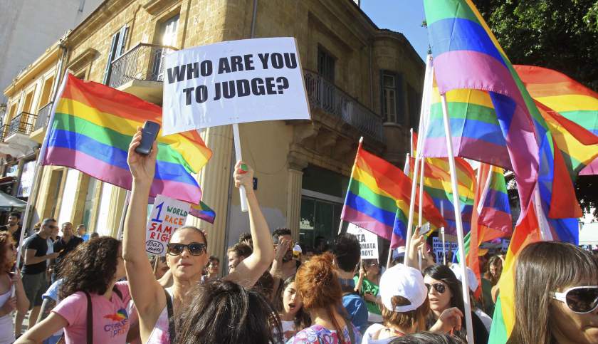 People hold rainbow flags and signs as they take part in a gay pride parade in Nicosia, Cyprus, May 31, 2014. u00e2u20acu201d Reuters pic