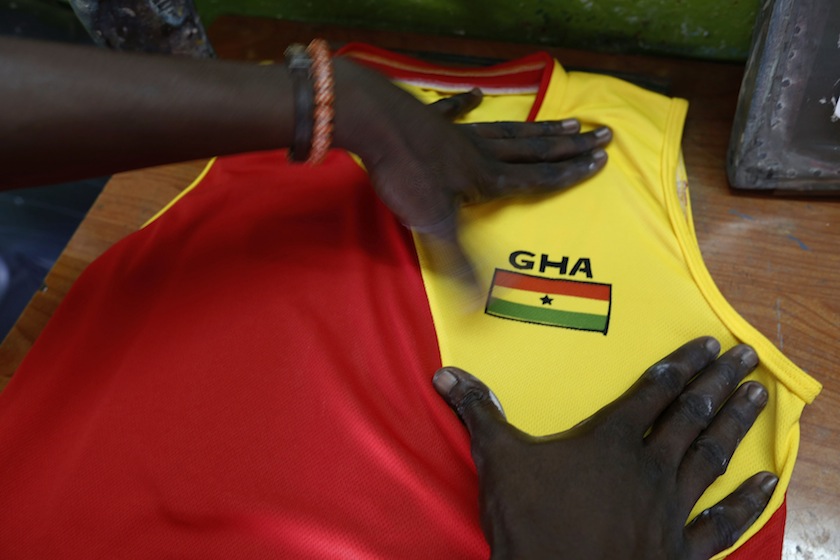 An employee works at a jersey workshop in the Adjame district of Abidjan June 3, 2014. u00e2u20acu201du00c2u00a0Reuters pic