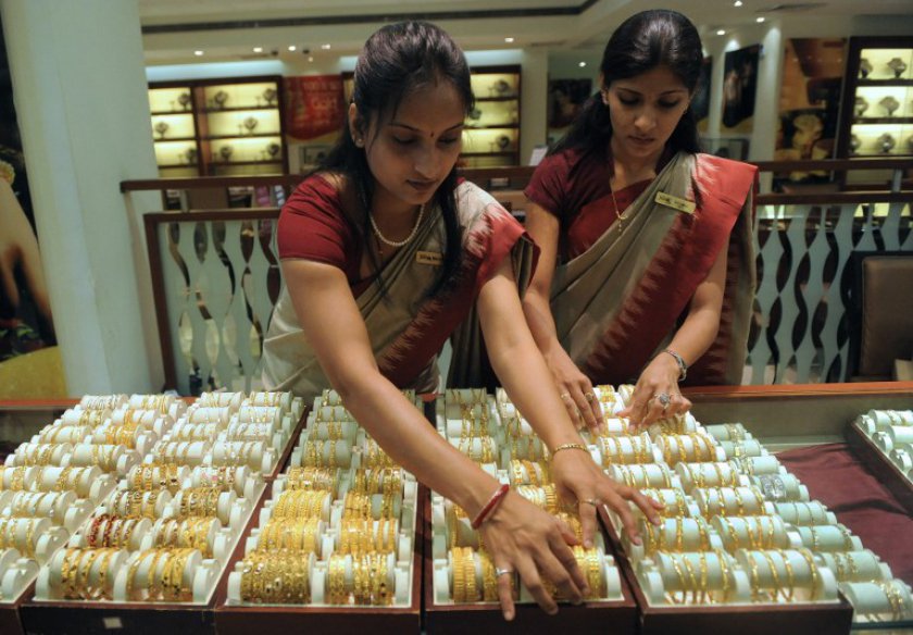 File picture shows an Indian sales person arranging bangles made of gold and other precious metals on the eve of a Hindu festival, in Ahmedabad on April 23, 2012. u00e2u20acu201d AFP pic