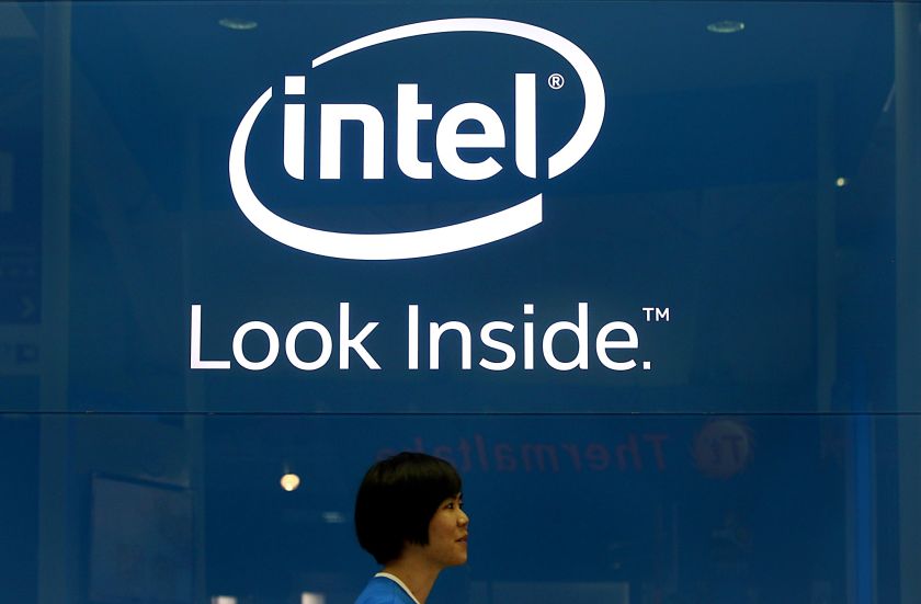 An employee walks past an Intel logo during the 2014 Computex exhibition at Taipei June 3, 2014. Intel showed off its no-touch technology enabling users to operate their devices with hand gestures. u00e2u20acu201d Reuters pic