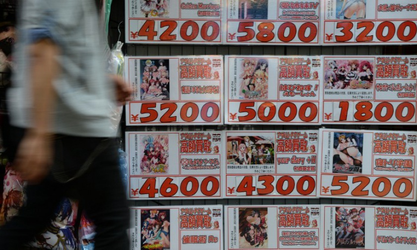 A man walks past advertisement of porn animation DVDs in front of a second-hand DVD shop in Tokyo on June 4, 2014. Japan on June 18, 2014 to banned the possession of child pornography, the last major developed country to do so. u00e2u20acu201d AFP pic