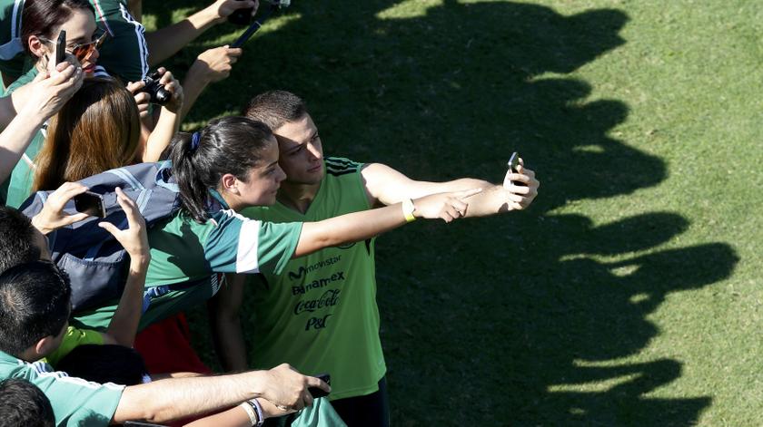 Mexico player Javier 'Chicharito' Hernandez poses for a picture with a fan after their training session in Santos prior to the 2014 World Cup in Sao Paulo June 8, 2014.u00c2u00a0u00e2u20acu201du00c2u00a0Reuters pic