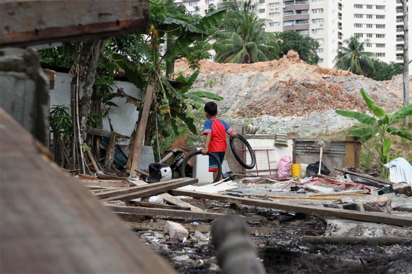 A child plays among the debris in Kg Chubadak, Sentul. — Picture by Yusof Mat Isa