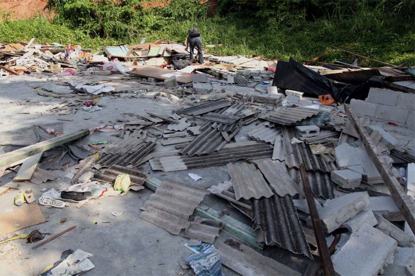 A man rummages among the debris for things that can be salvaged in Kg Chubadak after DBKL demolished some houses there. — Picture by Yusof Mat Isa