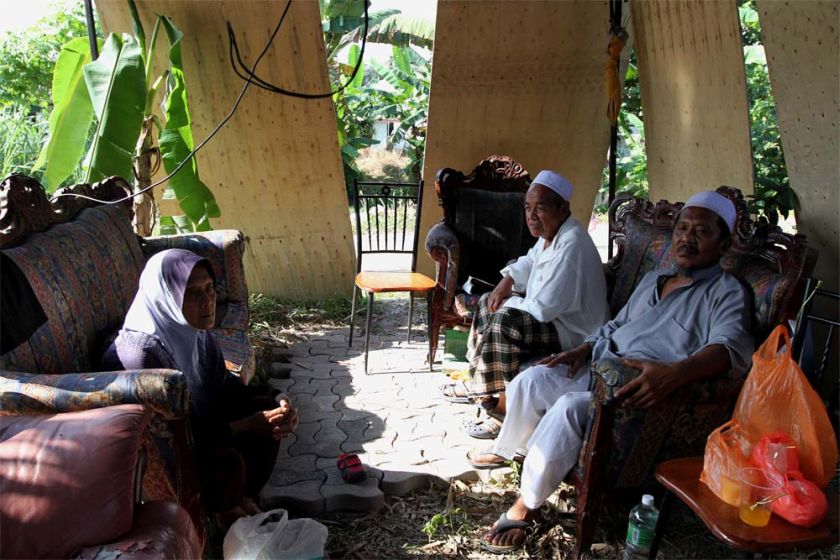 (from left) Wahidah Md Salleh,73 Halim Hamid, 75 and Abdul Hamid Mohd Saad,60 sit and chat amidst the demolished house at Kg Chubadak in Sentul, Kuala Lumpur. — Picture by Yusof Mat Isa