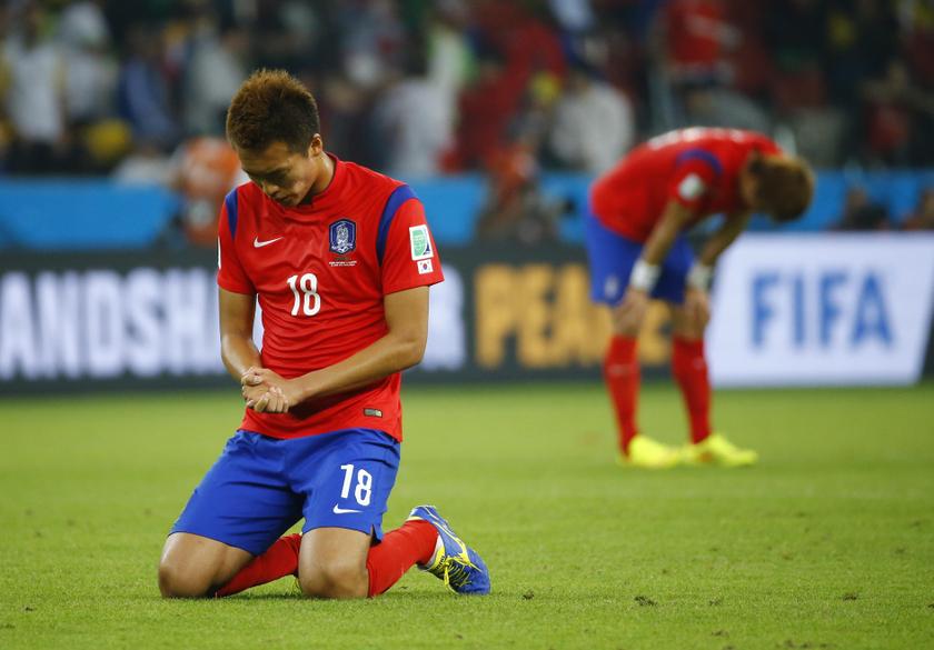 South Korea's Kim Shin-wook kneels on the ground as he reacts to his team's lost to Algeria after their 2014 World Cup Group H match at the Beira Rio stadium in Porto Alegre June 23, 2014.u00c2u00a0u00e2u20acu201d Reuters pic