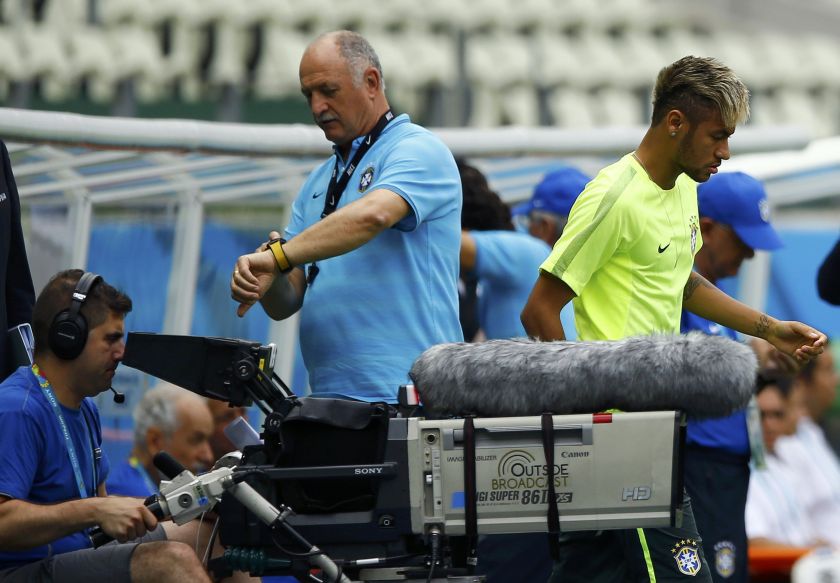 Brazil's national team player Neymar (right) walks past coach Luiz Felipe Scolari during a training session in Fortaleza, June 16, 2014. u00e2u20acu2022 Reuters pic  