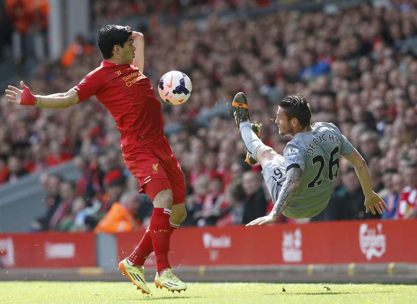 Liverpoolu00e2u20acu2122s Uruguayan striker Luis Suarez (left) challenges Newcastle Unitedu00e2u20acu2122s Mathieu Debuchy (right) during their EPL match at Anfield in Liverpool, England May 11, 2014. u00e2u20acu201d Reuters pic