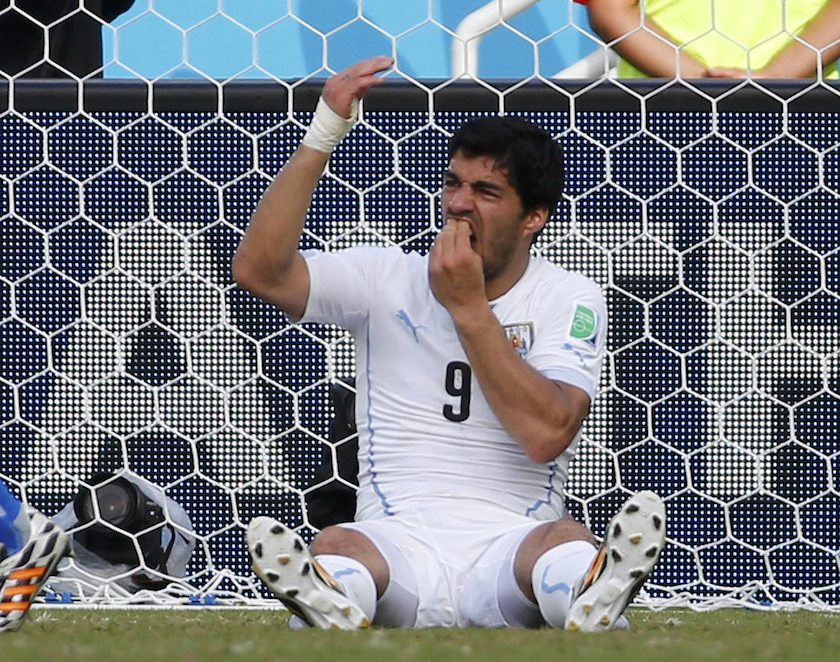 Uruguayu00e2u20acu2122s Luis Suarez holds his teeth during the 2014 World Cup Group D match between Uruguay and Italy at the Dunas arena in Natal June 24, 2014. u00e2u20acu201d Reuters pic