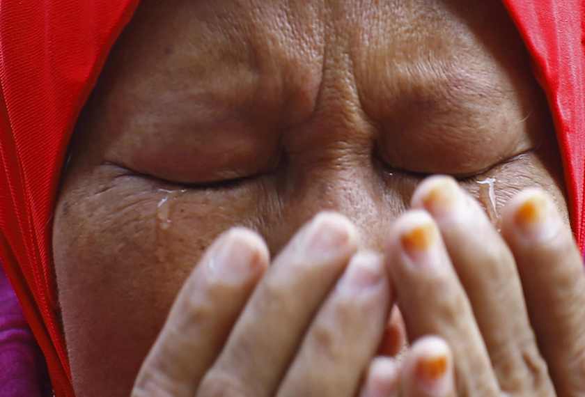 A Muslim woman cries as she recites a prayer outside the court in Putrajaya outside Kuala Lumpur June 23, 2014. u00e2u20acu201d Reuters pic