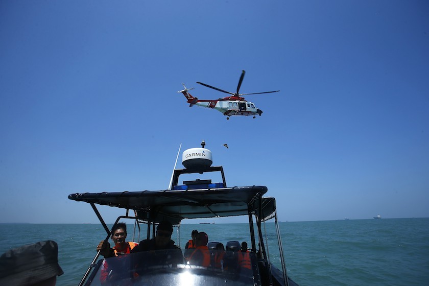 A Malaysia Maritime helicopter is seen in the air during a search and rescue for the suspected illegal Indonesian immigrants, off Malaysiau00e2u20acu2122s western coast, outside Kuala Lumpur June 18, 2014. u00e2u20acu201d Reuters pic
