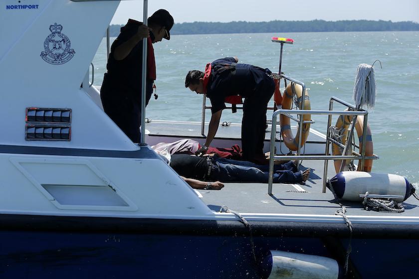 The two bodies of suspected illegal Indonesian immigrants are seen inside a Malaysian Port Police boat during a search and rescue with the Malaysia Maritime in Kuala Langat June 18, 2014. u00e2u20acu201d Reuters pic