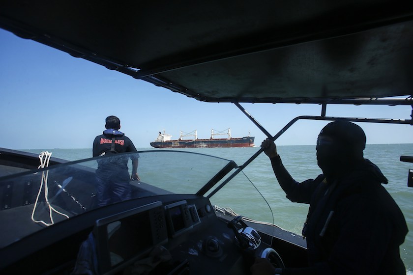A Malaysia Maritime officer looks out into the sea during a search and rescue in Kuala Langat June 18, 2014. u00e2u20acu201d Reuters pic