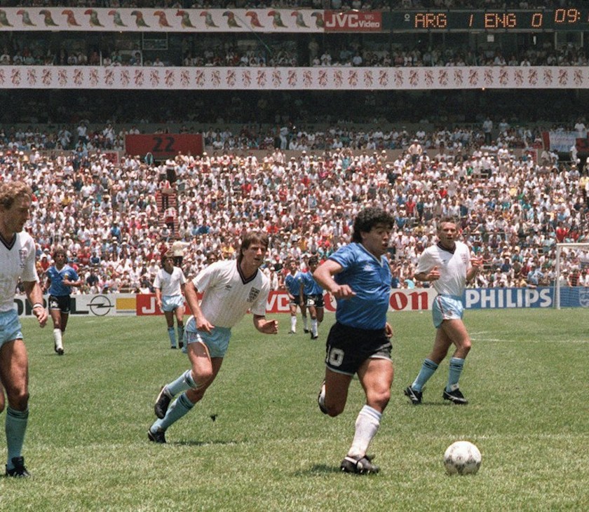 Argentinian forward Diego Maradona runs past English defenders Terry Butcher (left) and Terry Fenwick (2nd left) on his way to scoring his second goal during their World Cup quarterfinal match in Mexico City June 22, 1986. u00e2u20acu201d AFP pic 