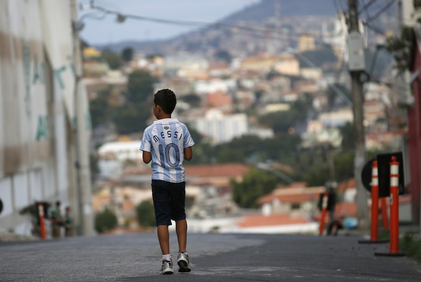 A boy wearing a jersey of Argentine star Lionel Messi walks on a street outside Independencia stadium before the start of the Argentine national team training session in preparation for 2014 World Cup in Belo Horizonte, June 11, 2014. u00e2u20acu201d Reuters pic
