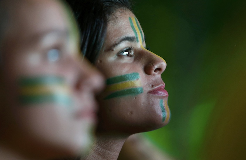 Girls in face paint watch a television broadcast of the 2014 World Cup match between Brazil and Mexico, in Mangaratiba June 18, 2014.u00c2u00a0u00e2u20acu201d Reuters pic