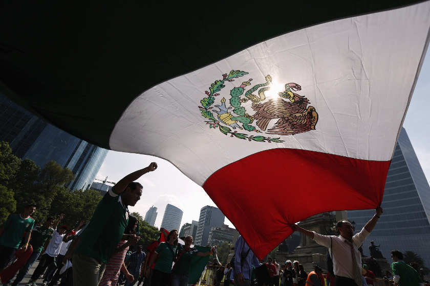 Mexican fans hold a Mexican national flag as they celebrate the 0-0 draw between Mexico and Brazil in their 2014 World Cup match, at the Angel of Independence monument in Mexico City June 17, 2014. u00e2u20acu201d Reuters pic