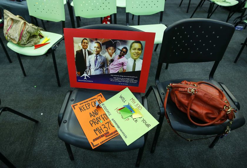 A message and  poster for Malaysia Airlines MH370 crew members is seen on a chair during the100 Days Remembrance of MH370 in  Kuala Lumpur June 15, 2014. u00e2u20acu201d Reuters pic