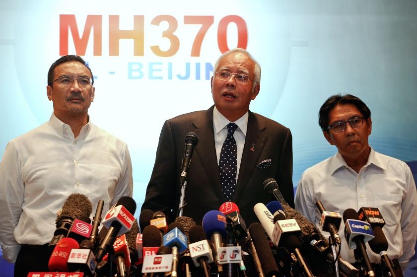 Datuk Seri Najib Razak (centre) addresses reporters about the missing Malaysia Airlines flight MH370, as Transport Minister Hishammuddin Hussein (left) and Department of Civil Aviation's Director General Azharuddin Abdul Rahman (right) stand by him, at th