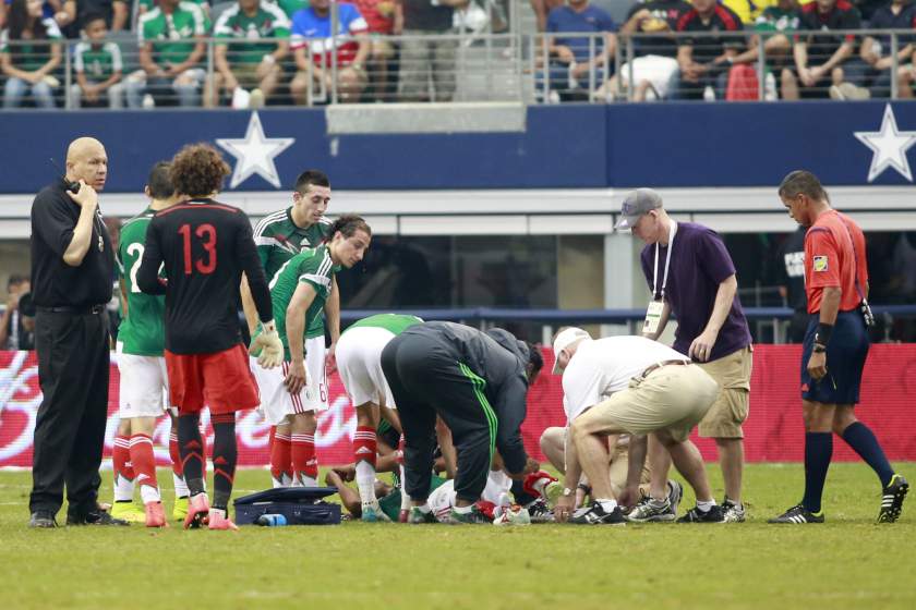 Mexico midfielder Luis Montes (20) is attended to by doctors after being injured against Ecuador during a football friendly at AT&T Stadium, Arlington, Texas. Mexico defeated Ecuador 3-1. u00e2u20acu201d Tim Heitman-USA TODAY/Reuters pic