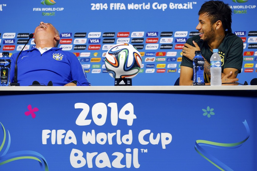 Brazil's national team coach Luiz Felipe Scolari (left) and his player Neymar laugh as they address reporters before their team's final practice in Sao Paulo, one day before the opening match of the World Cup between Brazil and Croatia, June 11, 2014.u00c2u00a0u00e2u20ac
