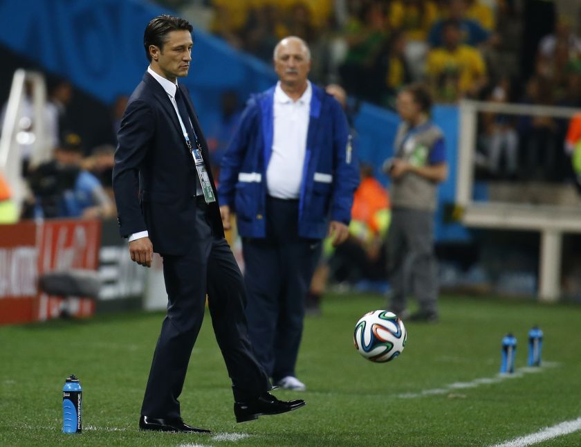 Croatia's coach Niko Kovac (left) kicks a football as Brazil's coach Luiz Felipe Scolari looks on during their 2014 World cup opening match between Brazil and Croatia at the Corinthians arena in Sao Paulo June 12, 2014. u00e2u20acu201d Reuters pic