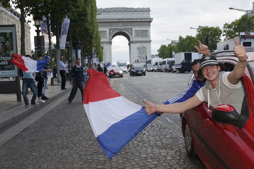 France team fans wave a flag to celebrate on the Champs Elysees near the Arc de Triomphe after the 2014 World Cup round of 16 game between France and Nigeria at the Brasilia national stadium in Brasilia, in Paris, July 1, 2014.u00c2u00a0u00e2u20acu201d Reuters pic