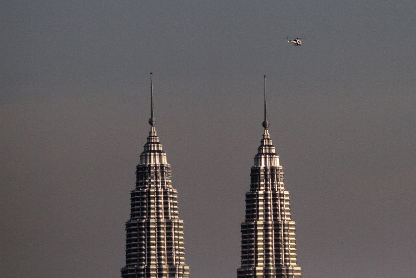 A helicopter is seen hovering over the Petronas Twin Towers in Kuala Lumpur, June 18, 2014. u00e2u20acu2022 Picture by Yusof Mat Isa
