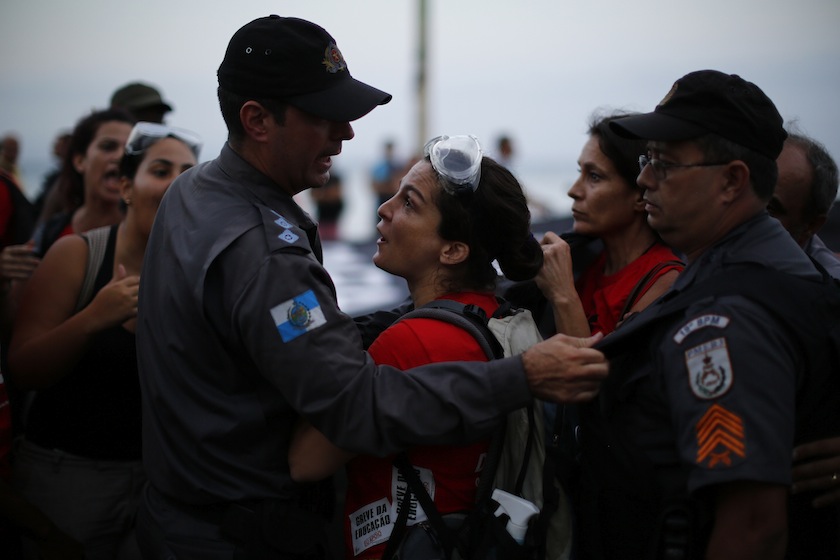 An anti-FIFA World Cup demonstrator speaks with the police during a march at Copacabana beach in Rio de Janeiro June 10, 2014.u00c2u00a0u00e2u20acu201d Reuters pic
