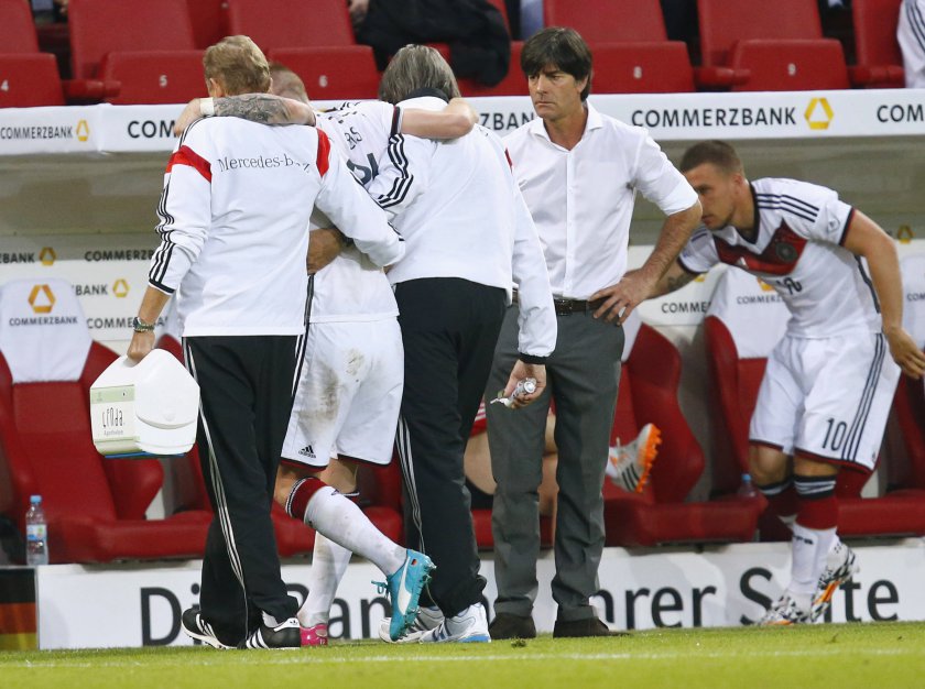 Germanyu00e2u20acu2122s injured player Marco Reus (second left) leaves the pitch next to coach Joachim Loew (fourth left) during their international friendly match in Mainz June 6, 2014. u00e2u20acu201d Reuters pic