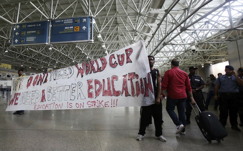 Teachers hold a banner during a protest against the World Cup after the arrival of the Brazilian players at the international airport in Rio de Janeiro May 26, 2014. u00e2u20acu201d Reuters pic