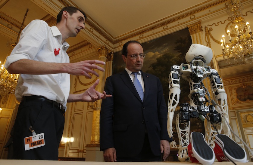 France's President Francois Hollande (centre) looks at a robot after a meeting with French high tech investors at the Elysee Palace in Paris June 11, 2014.u00c2u00a0u00e2u20acu201d Reuters pic
