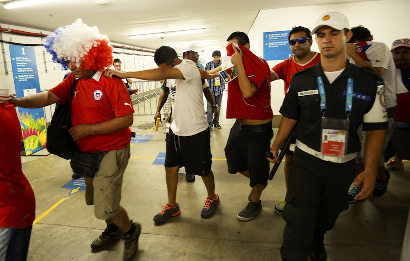 Chile fans are escorted by police after dozens of them crashed a gate to enter Maracana stadium and watch their country play Spain for Group B of the 2014 World Cup, in Rio de Janeiro June 19, 2014.u00c2u00a0u00e2u20acu201d Reuters pic