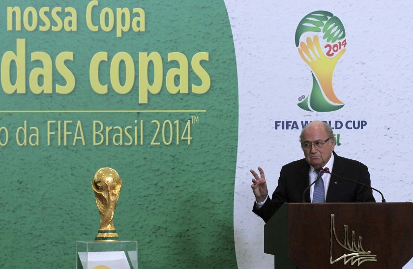 FIFA President Sepp Blatter speaks next to the World Cup trophy during a ceremony at the Planalto Palace in Brasilia June 2, 2014. FIFA is investigating allegations of corruption concerning a former Oceania official. u00e2u20acu201d Reuters pic