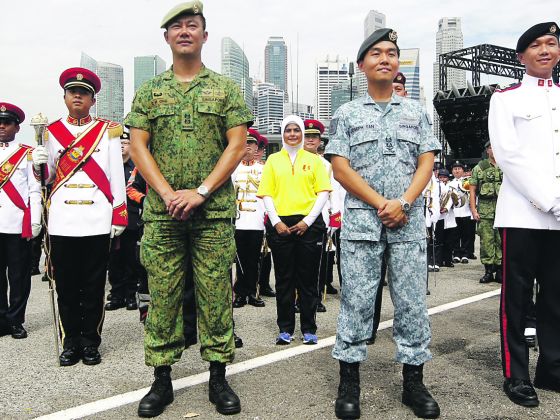 Salbiah Jamaludin (in yellow) with uniformed personnel at the floating platform during a parade media preview. u00e2u20acu201d Photo: Don Wong/TODAY pic