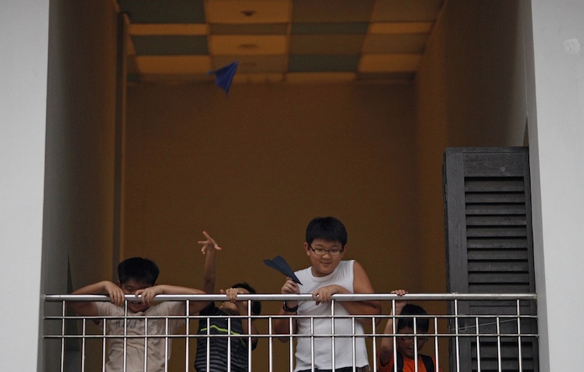 Children compete in throwing paper planes, at a public housing estate in Singapore June 10, 2014.  u00e2u20acu201d Reuters pic