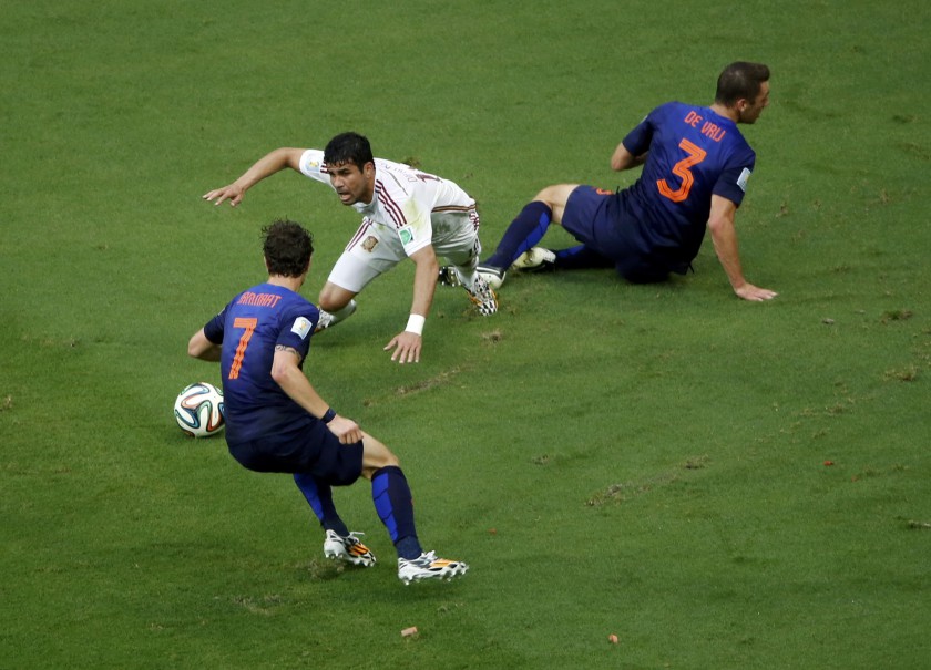 Spainu00e2u20acu2122s Diego Costa (centre) is fouled by Stefan de Vrij (right) of the Netherlands in the area to concede a penalty during their World Cup Group B match in Salvador, June 13, 2014. u00e2u20acu201d Reuters pic