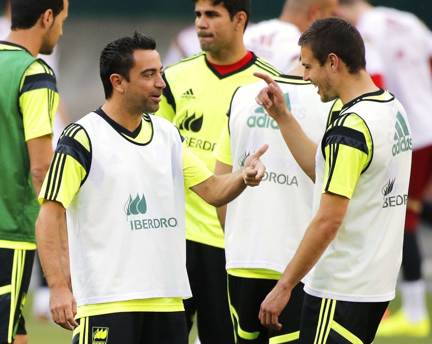 Spain's national football team player Xavi Hernandez (left) talks to teammate Cesar Azpilicueta (right) as they take the pitch for their training session at RFK Stadium in Washington June 5, 2014. u00e2u20acu2022 Reuters pic